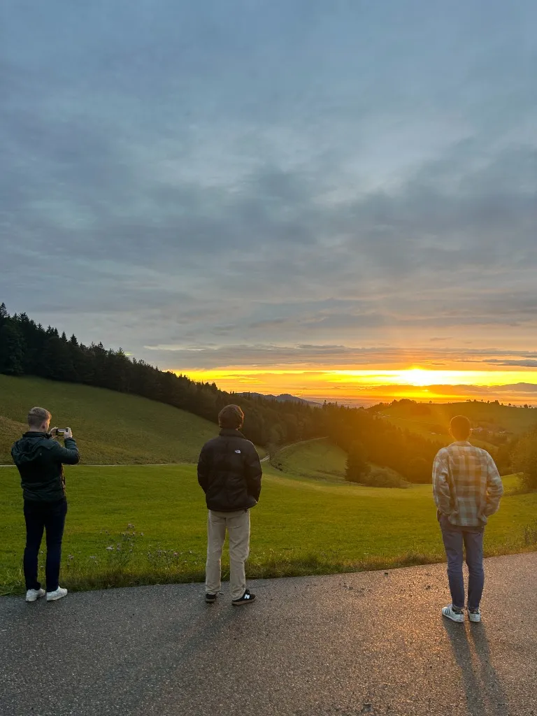 The team watching the sunset on a walk during an offsite