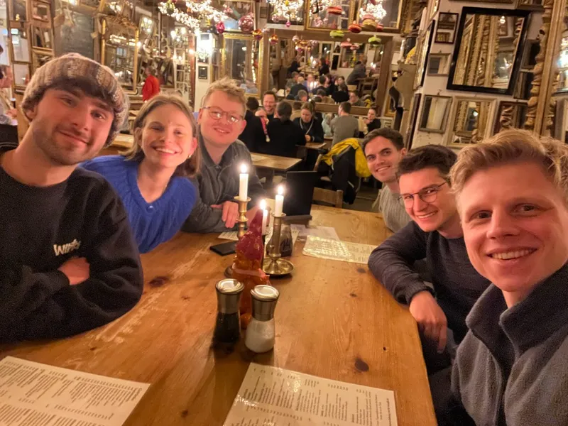 The Capacities team around a candlelit table at an offsite