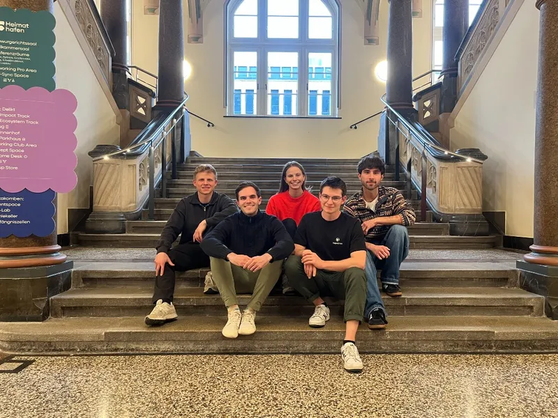 The Capacities team together on the stairs at an offsite